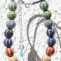 Necklace with seventeen multicolored ceramic beads on a leather cord: "Mexico"