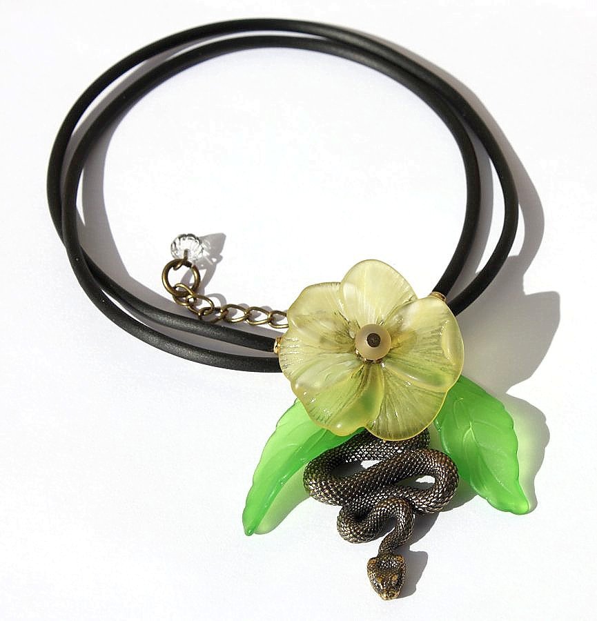 Pendant necklace with a snake adorned with a flower and leaves on a rubber cord:"Temptation"