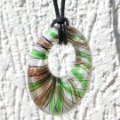 Necklace with oval glass pendant with golden and green zebra stripes on leather cord: "Zebrinus"