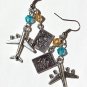 Silvered earrings with a plane and a passport adorned with a yellow and blue pearl: "Airlines"