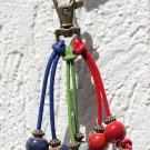 Bronze bag charm with six colored ceramic beads on leather cord: "Ceramiook" Mod 01