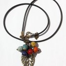 Necklace with a bronze leaf adorned with six colored ceramic beads: "Effeuillade"