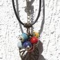 Necklace with a bronze leaf adorned with six colored ceramic beads: "Effeuillade"