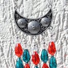 Necklace with a silvered half-moon adorned with ten red and blue glass drops:"Moon drops"