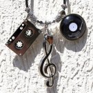 Necklace with silvered charms relating to the music of the 60s and 70s: "Oldies"