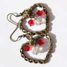 Bronze earrings with a twisted heart and inside red crystal pearls and a transparent "cracked" pearl