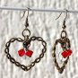 Bronze earrings with a twisted heart and inside red crystal pearls and a transparent "cracked" pearl