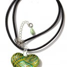 Pendant with a heart in greent and yellow stripes on leather cord:"Zébrina"