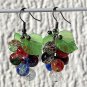 Bronze earrings with a cluster of multicolored and cracked glass beads and lucite leaves: "Grappa"