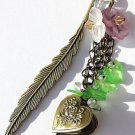 Bronze bookmark in the shape of a feather with a photo holder heart with green leaves and flowers