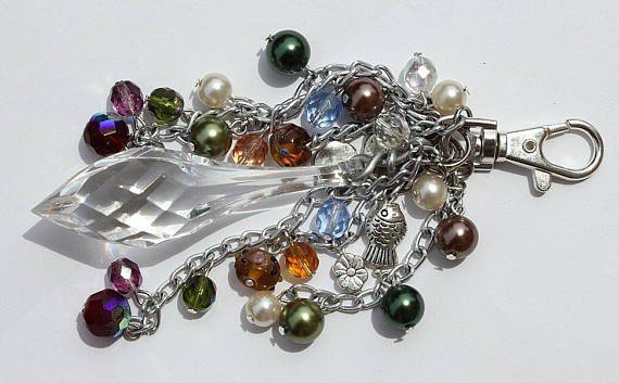 Bag charm with a big transparent central drop and various multicolored glass beads and charms