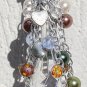 Bag charm with a big transparent central drop and various multicolored glass beads and charms