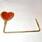 Nifty little heart-shaped item that holds your purse at the table~keep it close