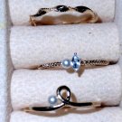 Three very dainty size 7 gold rings one with the Pearl and one with a cz