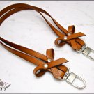 Cognac leather bag handle with bows, 52/62 cm. - silver / gold finishes