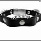 Unisex bracelet in black leather with rivets and silver-colored intertwined chain, magnetic closure.