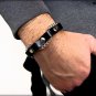 Unisex bracelet in black leather with rivets and silver-colored intertwined chain, magnetic closure.