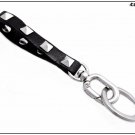 Leather keychain with pyramidal studs, 6 colors available, length 13 cm, silver finishes.