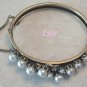 Florenza Gold Tone Faux Pearl Bangle Bracelet Designer