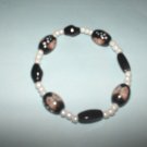 Black glass bead stretch bracelet with butterfly design