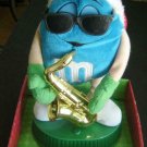Blue M & M MUSICAL Animation Rock Around the Christmas Tree Santa Hat Sax Works