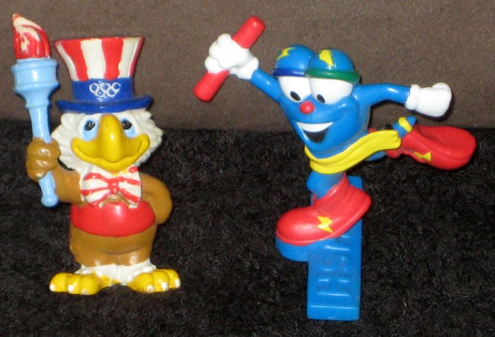 Olympic Games PVC Figure Lot of 2 Izzy Sam the Eagle Atlanta Los Angeles Torch Track and Field