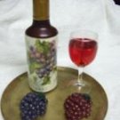 Wax wine bottle and grapes