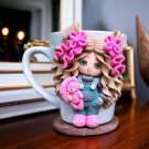 A hand made mug withdecor doll made of polymer clay.