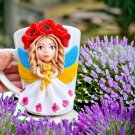 A hand made mug stand with ukraine made of polymer clay.