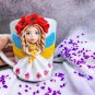 A hand made mug stand with ukraine made of polymer clay.