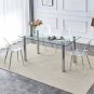 A modern minimalist style glass dining table. Transparent tempered glass tabletop