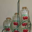 SET OF THREE GLASS BOTTLES CHERRIES CRUETS WIRE BASKET HOLDER