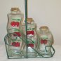 SET OF THREE GLASS BOTTLES CHERRIES CRUETS WIRE BASKET HOLDER