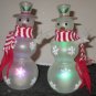 TWO BATTERY OPERATED HANDICAP SNOW PEOPLE SNOWMEN