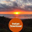 Coastal Eve: Fiery Sunset Skies Above the Beach