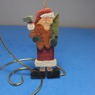 Santa Claus Figurine holding Christmas Tree Ornament