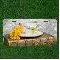 Creative License Plate Auto Tag With Fancy Cup And Yellow Flowers On Book