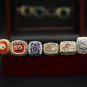 A Set Denver Broncos Super Bowl Championship Rings With Wooden Display