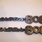 MAZDA 808 EMBLEMS PAIR OEM #752469053 1971 1972 1973 1974 1975 1976 1977 1978 ? MAZDA 808 EMBLEMS PAIR OEM #752469053 1971 1972 1973 1974 1975 1976 1977 1978 ?