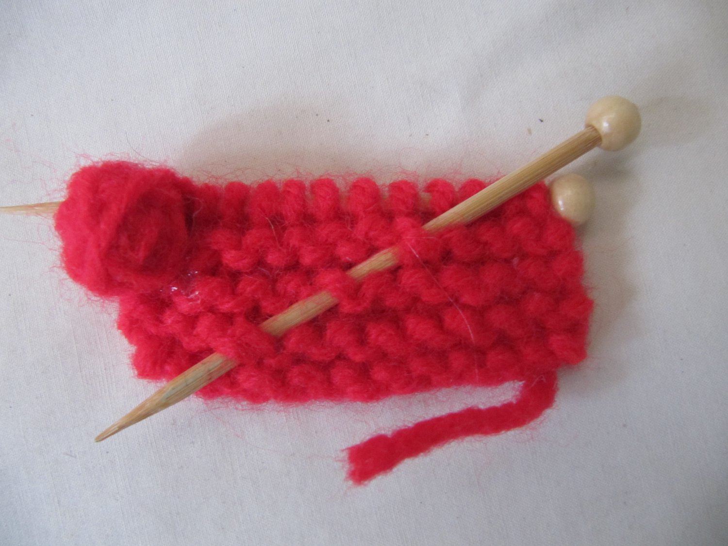 Miniature knitting swatch refrigerator magnet red yarn tiny needles