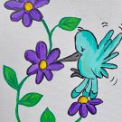 Turquoise hummingbird with purple flowers