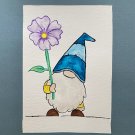 Garden Gnome with a blue hat and purple flower