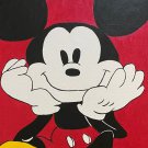 Mickey Mouse seated and smiling