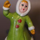 Vintage Ceramic Figural Bell – Waving Girl in Green Winter Coat Vintage Ceramic Figural Bell – Waving Girl in Green Winter Coat
