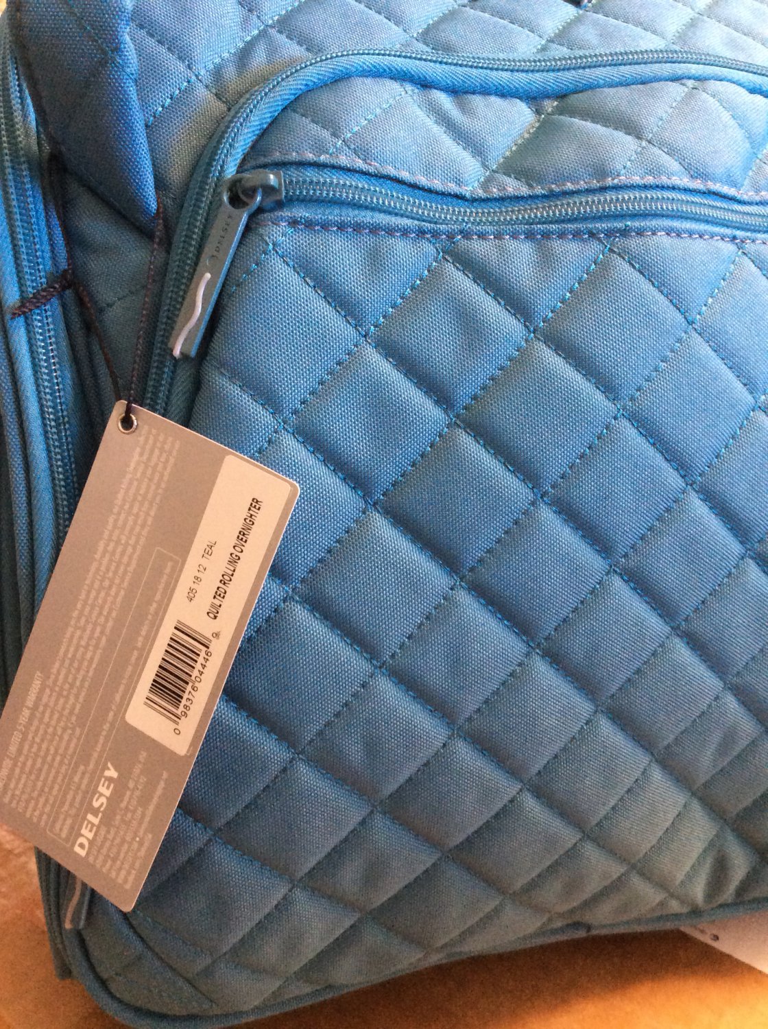 Delsey Quilted Overnighter rolling underseat wheeled tote Teal blue aqua