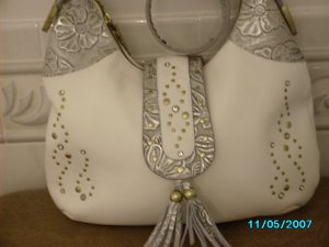 Charm and Luck pebbled leather designer handbag.
