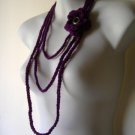 the long flower necklace in eggplant purple.