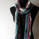 the twisted colors scarf in gray, teal, cream, and purple.