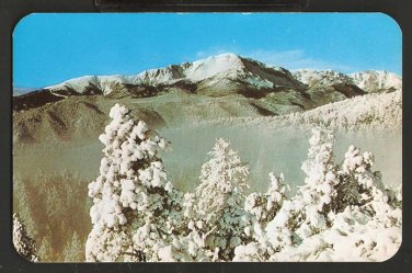 PIKES PEAK IN WINTER ATTIRE SEEN FROM RAMPART RANGE ROAD 837