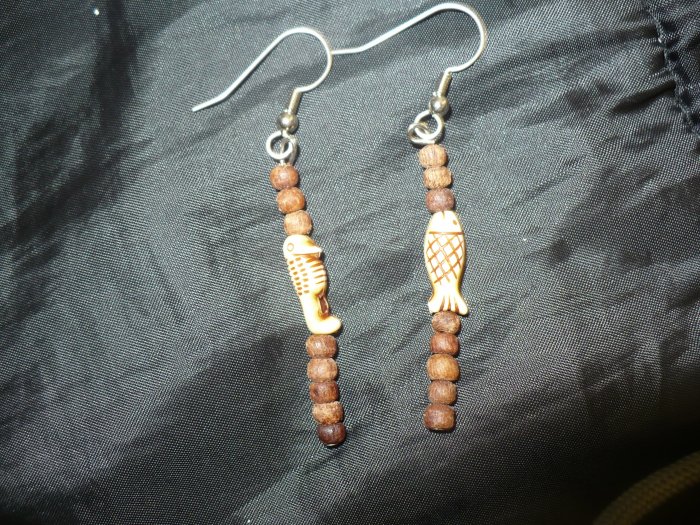 earrings made with round wood beads and beads shaped like fish
